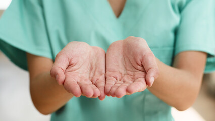 Close-Up of Open Hands in Medical Uniform Suggesting Caring and Compassion