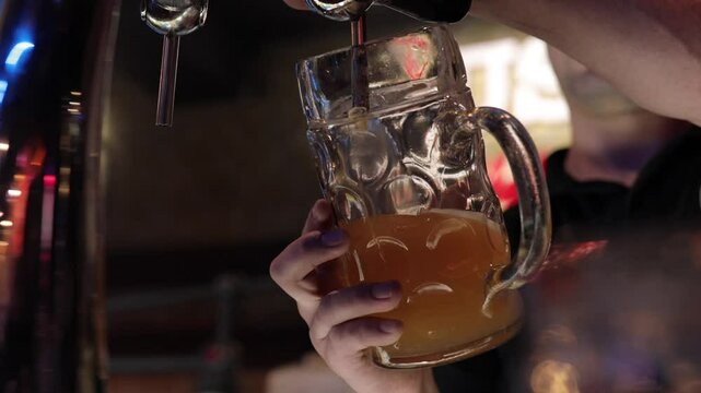 Bartender pouring beer at the bar. Close up hands