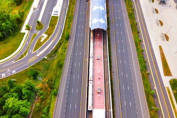 Aerial view of a subway station in Ashburn, Virginia. There is parking and bus stops nearby.