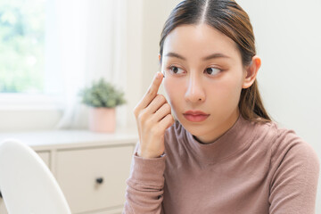 Ophthalmology care, eyesight or vision. Asian young woman, girl hand holding and putting, wearing...
