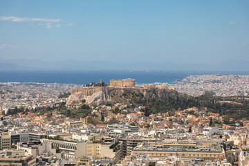 The panoramic view of the Acropolis in Athens from a hill in sunny day