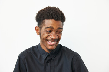 A joyful black man smiling, wearing a stylish black shirt. His expression radiates positivity and confidence, perfect for diverse projects and campaigns.