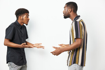 Two African American men engaging in a heated discussion, expressing strong emotions. The...