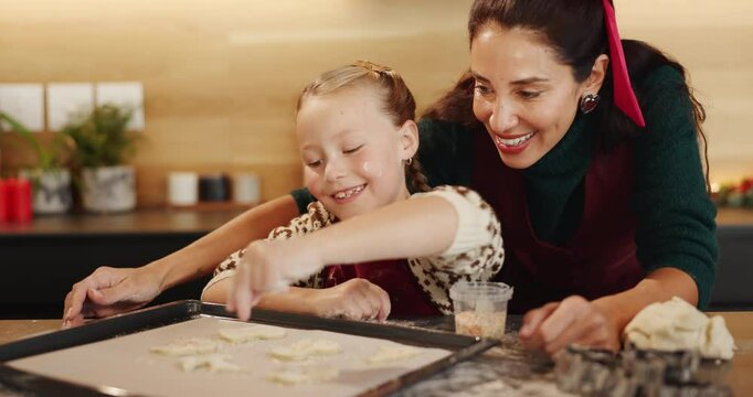 Christmas, baking and festive cookies with child and mother together for sprinkles and help. Bonding, tradition and family home to teach kid to bake homemade xmas treats to celebrate a holiday