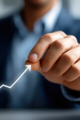 Caucasian male hand pointing to rising arrow symbolizing business growth and success