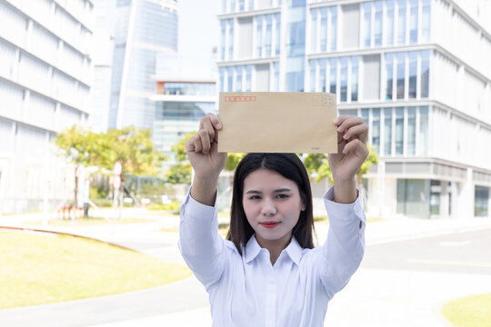 Job hunting concept: a Chinese woman holding a job application letter