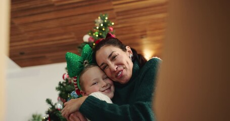 Happy mom, child and Christmas with gift box or surprise below for holiday present in home. Excited, mother or kid opening package with smile, wow or thank you with hug or giving POV in house - Powered by Adobe