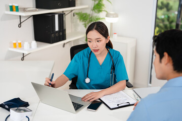 Female doctor giving a consultation to a patient and explaining medical informatics and...