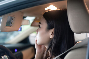 
Young professional women in China are doing their makeup in a small car
