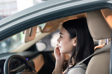 
Young professional women in China are doing their makeup in a small car
