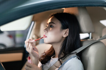 
Young professional women in China are doing their makeup in a small car

