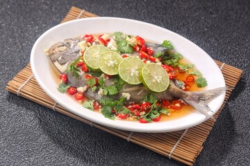 Thai steamed fish served with a bright, punchy  with lots of lime, garlic, chillies, fish sauce and other fragrant aromatics.