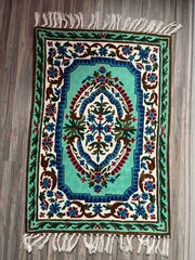 Traditional Kashmiri handmade carpet with intricate floral motifs, crafted by artisans using...