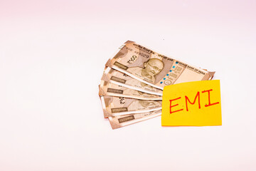 Indian 500 Rupee Notes with EMI Sticky Note Symbolizing Financial Stress and Loan Burden