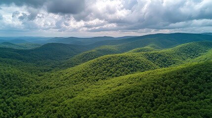 Scenic green forested mountains with a blanket of clouds in the sky