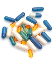 Large pile of multicolored capsules including blue, green, orange, white, and transparent pills on a clean white background, isolated, vertical format