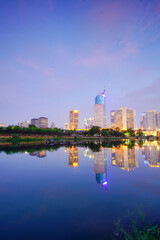 Fototapeta premium Modern Cityscape Reflecting in Water at Dusk