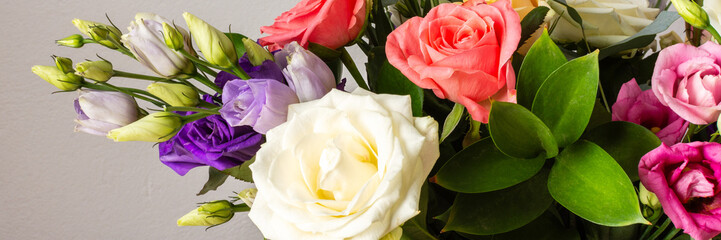 This seasonal bouquet of roses, eucalyptus, and eustoma in soft pink, white, and purple tones makes...