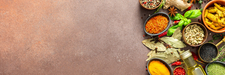 A visually striking arrangement of fresh spices and herbs on a brown surface, highlighting their...