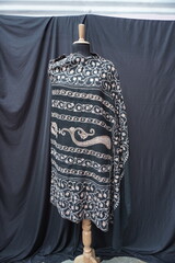 Elegant display of Kashmiri shawls draped on a mannequin, featuring intricate Sozni embroidery that...