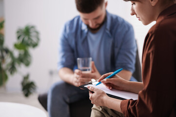 Professional psychologist working with patient in office, selective focus