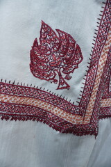 Elegant display of Kashmiri shawls draped on a mannequin, featuring intricate Sozni embroidery that...
