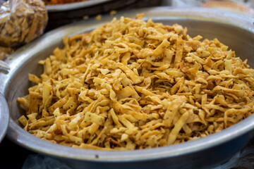 There are many Chanachur in a sack, and a part of it is blurred.