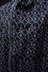 Elegant display of Kashmiri shawls draped on a mannequin, featuring intricate Sozni embroidery that...