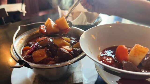Hungarian Cuisine Concept. Traditional goulash meat soup close up. High quality 4k footage
