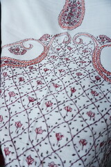 Elegant display of Kashmiri shawls draped on a mannequin, featuring intricate Sozni embroidery that...