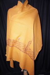 Elegant display of Kashmiri shawls draped on a mannequin, featuring intricate Sozni embroidery that...