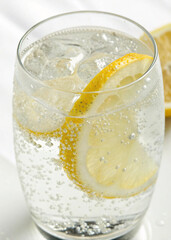 A crisp, cool, and bubbly drink with lemon slices, highlighting its thirst-quenching and pure qualities.