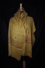 Elegant display of Kashmiri shawls draped on a mannequin, featuring intricate Sozni embroidery that...