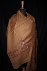 Elegant display of Kashmiri shawls draped on a mannequin, featuring intricate Sozni embroidery that...