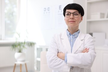 Portrait of professional ophthalmologist in clinic, space for text