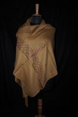 Elegant display of Kashmiri shawls draped on a mannequin, featuring intricate Sozni embroidery that...