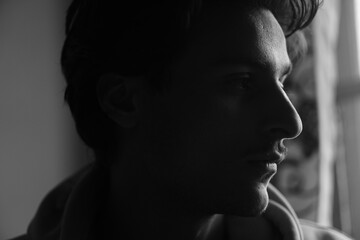 Moody black and white portrait of a young Kashmiri Gen Z boy, capturing raw emotion, identity, and the quiet strength of youth in a timeless frame.

