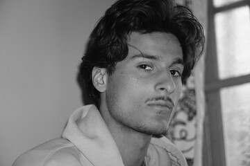 Moody black and white portrait of a young Kashmiri Gen Z boy, capturing raw emotion, identity, and...