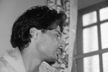 Moody black and white portrait of a young Kashmiri Gen Z boy, capturing raw emotion, identity, and...