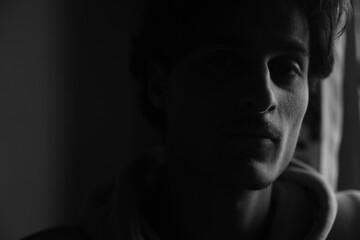 Moody black and white portrait of a young Kashmiri Gen Z boy, capturing raw emotion, identity, and the quiet strength of youth in a timeless frame.

