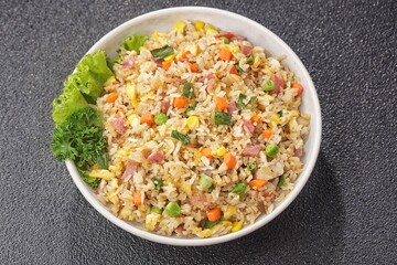 Nasi goreng Hongkong. Chinese Fried rice is a dish of cooked rice that has been stir-fried in a wok or a frying pan and is with other ingredients such as eggs, vegetables, seafood, or meat