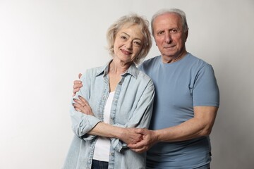 Portrait of lovely senior couple on white background
