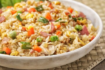 Nasi goreng Hongkong. Chinese Fried rice is a dish of cooked rice that has been stir-fried in a wok or a frying pan and is with other ingredients such as eggs, vegetables, seafood, or meat