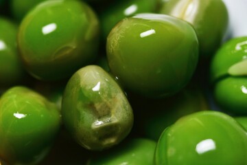Macro close-up of fresh green peas showing their smooth and round texture.