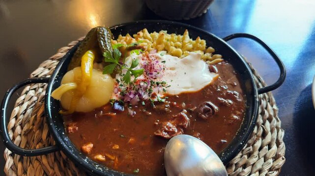 Paprikash. Traditional Hungarian dish consisting of stewed meat, chicken or veal, in a paprika and sour cream-based sauce with noodles. High quality 4k footage