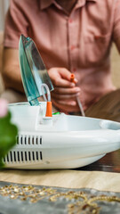 Man Using Steam Inhaler Device for Respiratory Therapy at Home