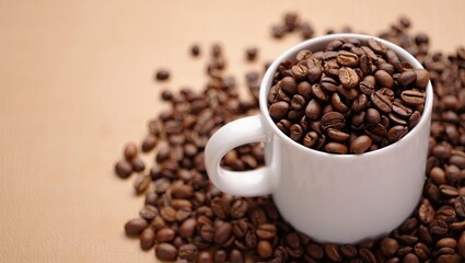 Fototapeta premium Roasted Coffee Beans in a White Mug