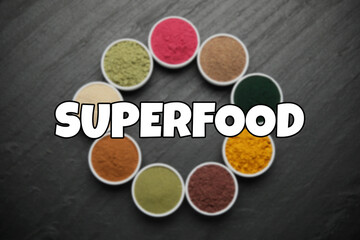 Superfood. Different powders in bowls on black table, flat lay