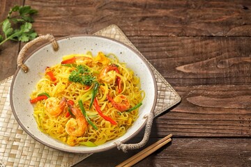 Singapore Mei Fun consists of rice vermicelli seasoned with curry powder, soy sauce and stir-fried with egg, shrimp