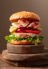 Fresh tasty burger on a wooden cutting board.